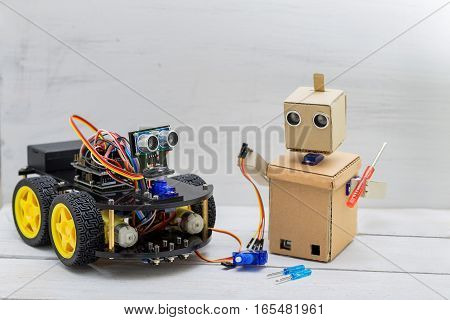 two robots are on the table the robot screwdriver and wire