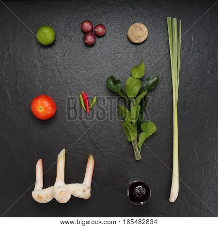 Mix ingredients of tom yum goong, composed of lime, shallot, straw mushroom, tomato, chili, kaffir lime leaf, lemongrass, galangal and chili paste