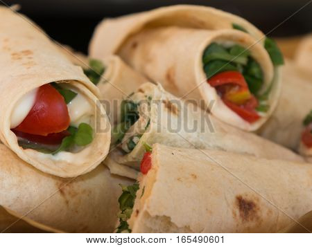 Italian Piadina Rolled And Filled With Cheese, Tomato And Argula: Typical Italian Flat Unleavened Br