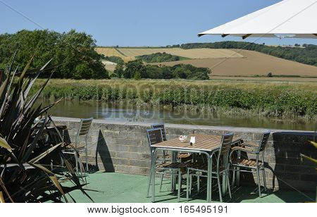 Cafe tables on terrace by River Arun at Amberley West Sussex England