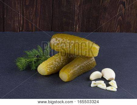 Pickles. Salted cucumbers of the wooden background. Pickles