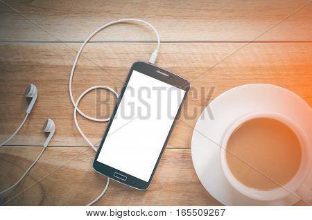 Coffee cup and smatphone on wood background
