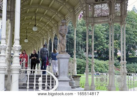 KARLOVY VARY CZECH REPUBLIC - SEPTEMBER 14 2014: tourists walk along Sadova Colonnade(Garden colonnade) on September 14 2014 in Karlovy Vary Czech Republic