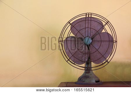 Antique Table Fan Electric Ventilator On Wood Table With Vintage Style Effect. Vintage Fan Concept.