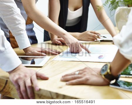 group of business people meeting in office discussing and reviewing sales performance.