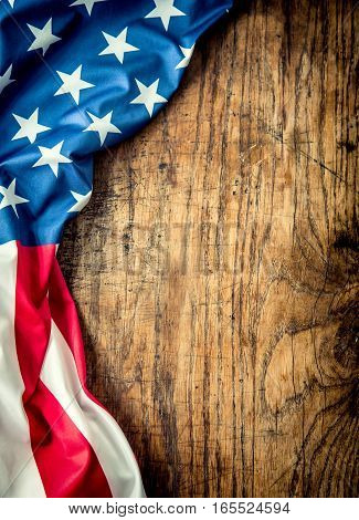 USA flag. American flag. American flag freely lying on wooden board. Close-up Studio shot. Toned Photo.