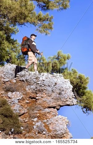 Summer hiking in the mountains with a backpack .