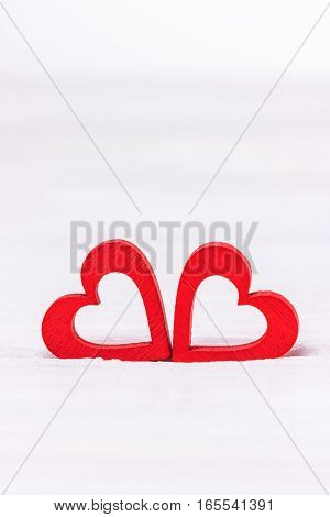 Two red hearts on a white background