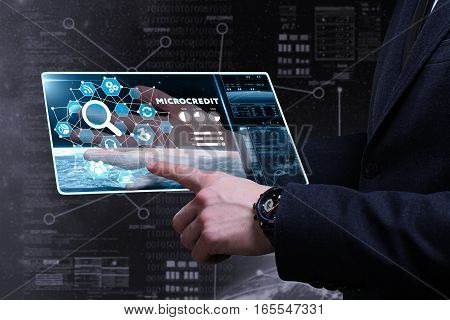 Business, Technology, Internet And Network Concept. Young Business Man Writing Word: Microcredit