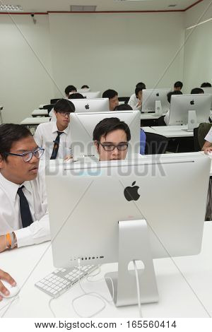 Bangkok, Thailand - November 17, 2015 : 
King Mongkut's Institute of Technology Ladkrabang is a research and educational institution in Thailand.
A class of students in front of their screens study computer science.