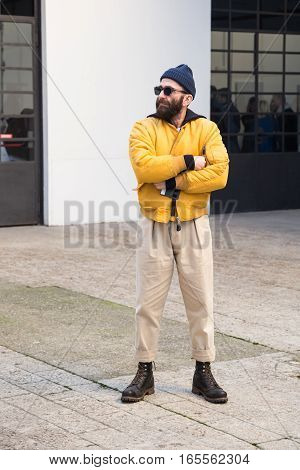 MILAN ITALY - JANUARY 15: Fashionable man poses outside Damir Doma fashion show building during Milan Men's Fashion Week on JANUARY 15 2017 in Milan.