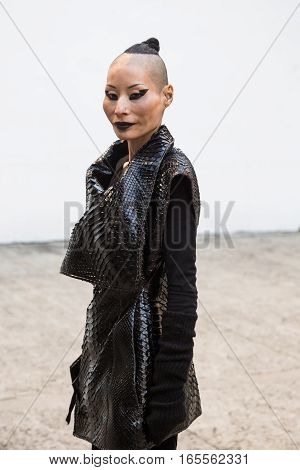 MILAN ITALY - JANUARY 15: Fashionable woman poses outside Damir Doma fashion show building during Milan Men's Fashion Week on JANUARY 15 2017 in Milan.
