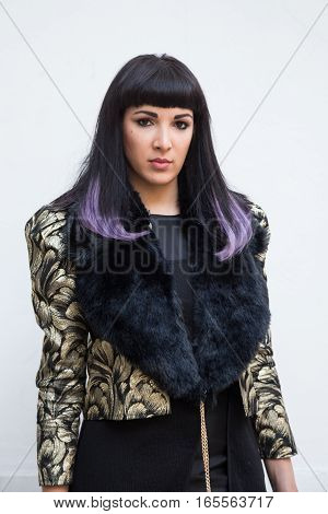 MILAN ITALY - JANUARY 15: Fashionable woman poses outside Damir Doma fashion show building during Milan Men's Fashion Week on JANUARY 15 2017 in Milan.