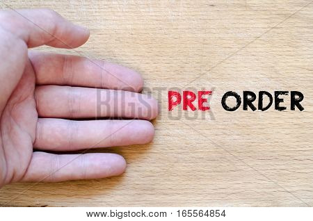 Human hand over wooden background and pre order text concept