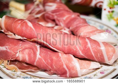 Breadsticks wrapped with thin slices of ham