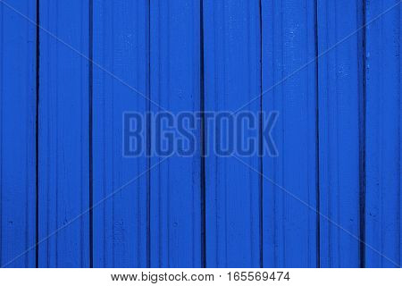 Texture of old wooden planks with peeling color paint