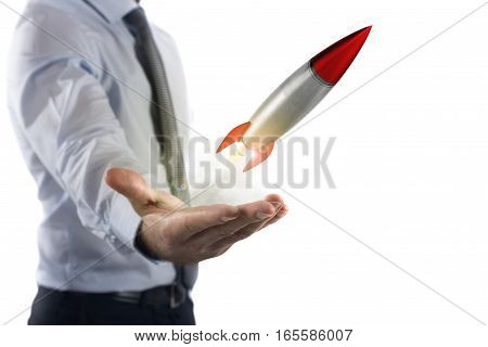 Businessman holding a small rocket. Startup working enterprise concept