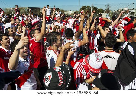 Buenos Aires Argentina - October 6 2013: River Plate supporters sing and dance while waiting for the stadium doors to open to attend a soccer game at the Estadio Monumental Antonio Vespucio Liberti in the city of Buenos Aires Argentina