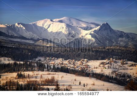 Winter Tatra mountains and Jurgow village in sunset light Poland