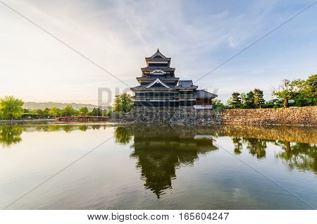 Matsumoto castle reflect on water in evening at nagano japan