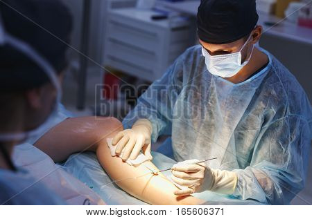 doctor and an assistant in the operating room for surgical venous vascular surgery clinic