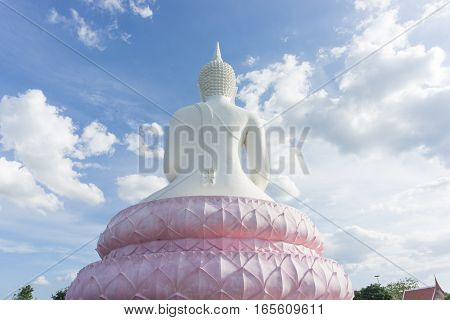 White Buddha statue on blue sky .