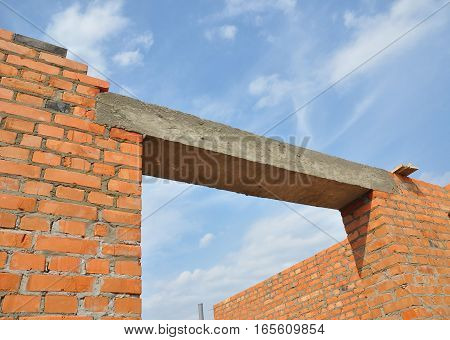Close up on concrete lintel. Window or door concrete lintel on brick unfinished house construction.