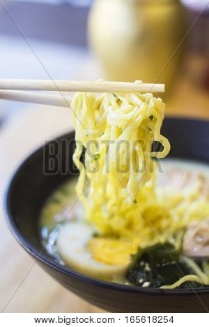 Chopsticks Ramen In line with a cup of Ramen and eggs for tasty on the table.