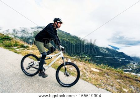 Young Man Cycling. Shot taken in Switzerland, near Rhone Glacier and Furka Pass.