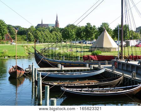 Moored Boats at the Pier and Roskilde City's Famous Landmark St. Luke Cathedral, Roskilde, Denmark