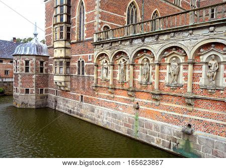 Impressive bricked wall and gorgeous decoration with sculptures at Frederiksborg Castle, Hillerod, Denmark
