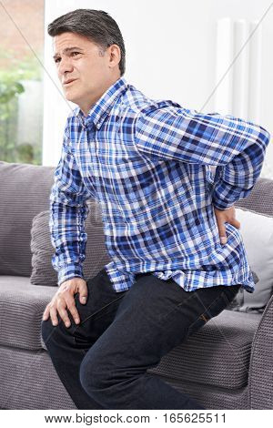Mature Man Suffering From Backache At Home
