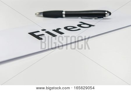 fired Letter and pen is on the white tabke
