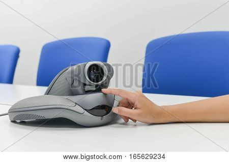 Human hand is adjusting thecamera of VDO IP conference device