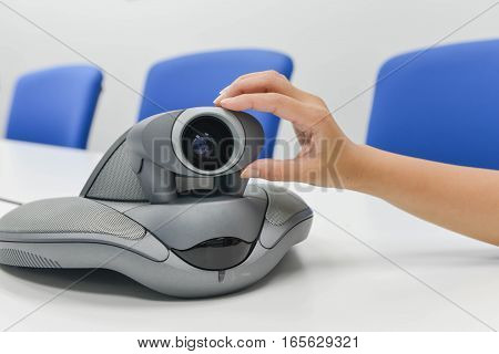 Human hand is adjusting thecamera of VDO IP conference device
