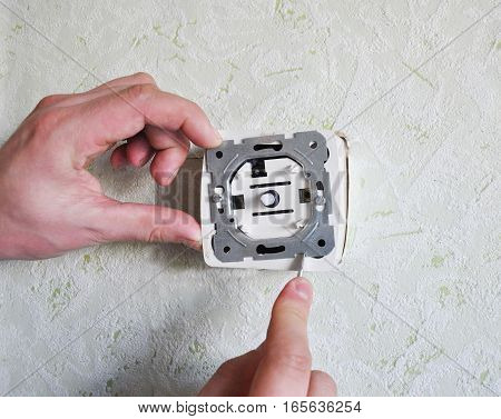 Close up on dimmer switch installation with contractor hands