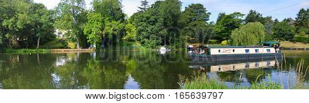 ST NEOTS, CAMBRIDGESHIRE, ENGLAND - JULY 24, 2016: Panorama of the River Ouse at St Neots with Narrow Boat.