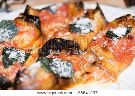Rolled slices of eggplant, stuffed with ham and cheese, served with tomato basil and grated Parmesan cheese and baked