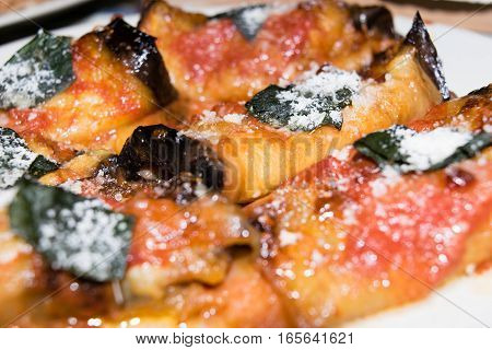 Rolled slices of eggplant, stuffed with ham and cheese, served with tomato basil and grated Parmesan cheese and baked