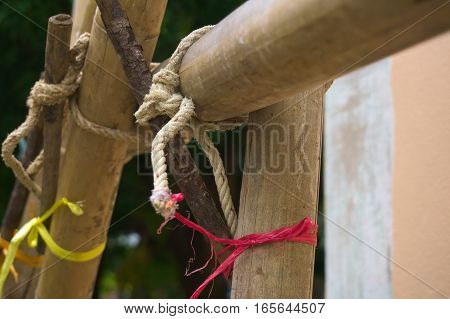 The scaffolding of bamboo lashed together with rope on the wrench.