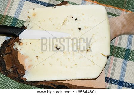 Cutting board with slice of pecorino cheese