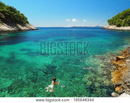 Woman swimming in the bright, clear sea