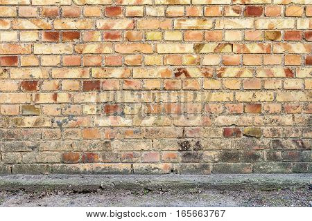 Yellow brick wall background with concrete basement