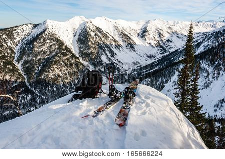 Splitboard backpack and ski poles on the mountain background