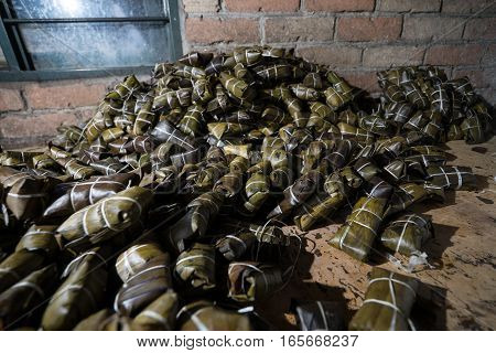 a pile of corn bread wrapped in natural leafs called 'envueltos' in Cayete Colombia