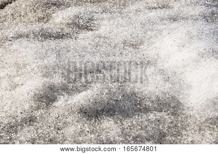 Snow with ice like a glass and crystal in early spring