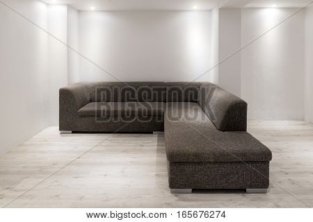 Sofa With Chaiselongue In Empty Renovated Apartment