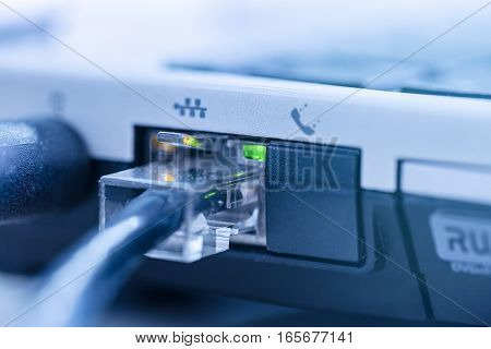LAN network cable connected to RJ-45 port notebook close up.