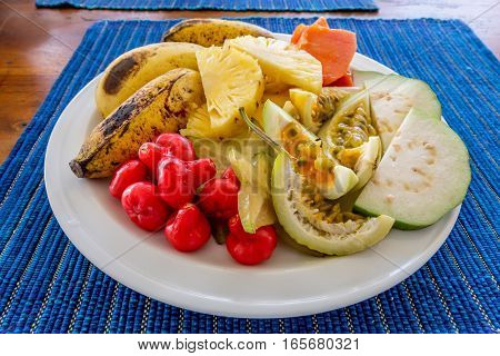 Plate with various juicy ripe exotic tropical fruits
