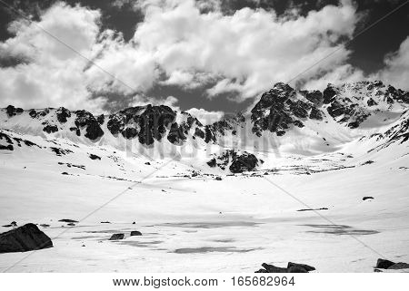 Black And White View On Frozen Mountain Lake Covered With Snow